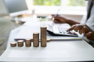 person sitting at computer calculating earnings